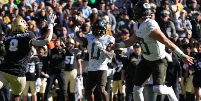 Running back Bucky Irving throws a touchdown to Bo Nix against Colorado.